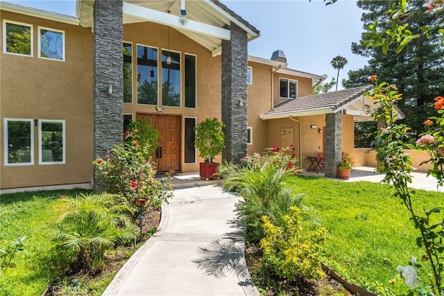 1377 Knoll Rd, Redlands, CA 92373 - view of front of home with stucco siding, stone siding, and a front lawn