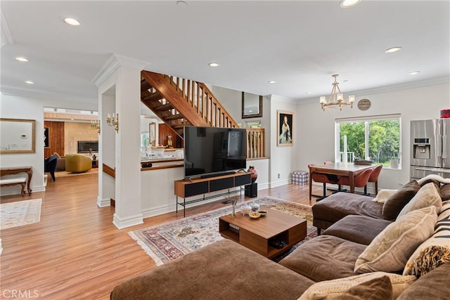 1377 Knoll Rd, Redlands, CA 92373 - living room featuring ornamental molding, light wood finished floors, a chandelier, stairs, and recessed lighting