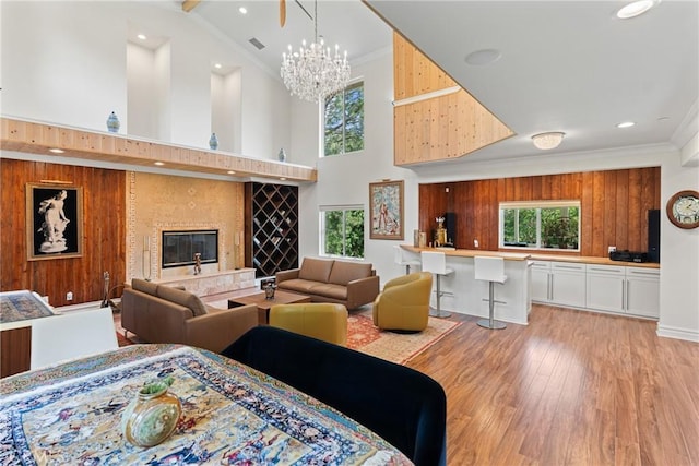 1377 Knoll Rd, Redlands, CA 92373 - living room with a high ceiling, plenty of natural light, light wood-type flooring, a chandelier, and crown molding