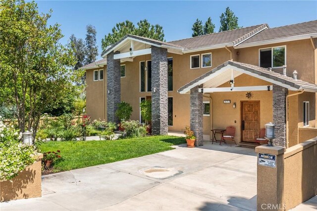 1377 Knoll Rd, Redlands, CA 92373 - view of front facade with stucco siding, stone siding, and a tile roof