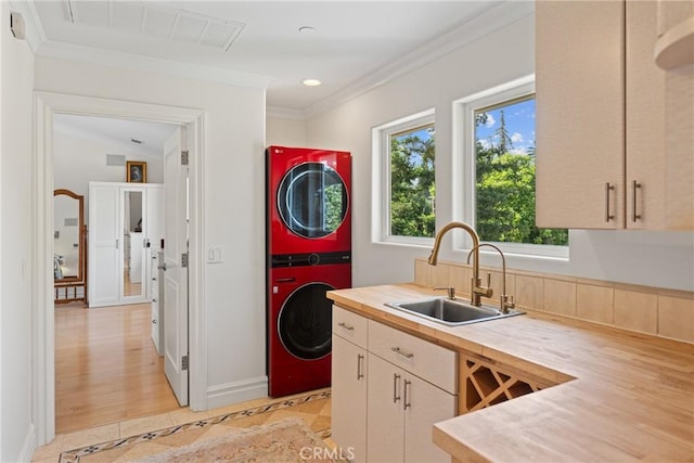 1377 Knoll Rd, Redlands, CA 92373 - kitchen featuring stacked washer and clothes dryer, healthy amount of natural light, ornamental molding, butcher block countertops, and recessed lighting