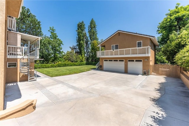 1377 Knoll Rd, Redlands, CA 92373 - view of side of home with an attached garage, stucco siding, concrete driveway, stairway, and a balcony