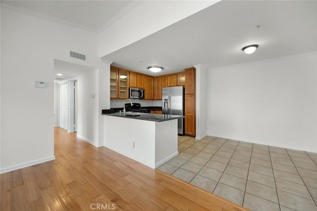 1995 Las Colinas Cir Unit 301, Corona, CA 92879 - kitchen with stainless steel appliances, glass insert cabinets, dark countertops, crown molding, and a peninsula