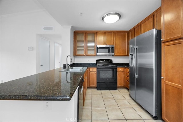 1995 Las Colinas Cir Unit 301, Corona, CA 92879 - kitchen featuring stainless steel appliances, brown cabinets, light tile patterned floors, glass insert cabinets, and a peninsula