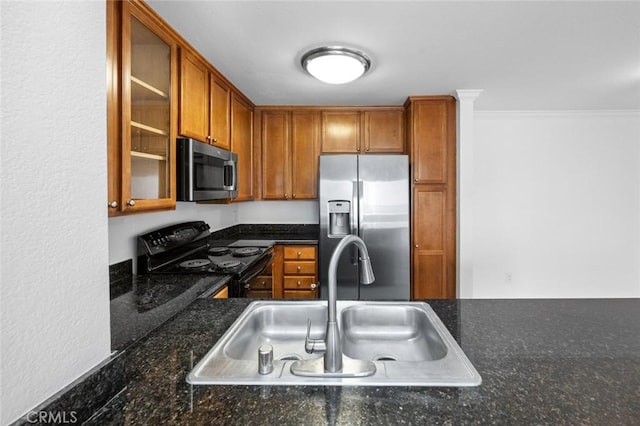 1995 Las Colinas Cir Unit 301, Corona, CA 92879 - kitchen with stainless steel appliances, brown cabinets, glass insert cabinets, crown molding, and dark stone counters