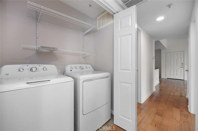 1995 Las Colinas Cir Unit 301, Corona, CA 92879 - laundry area featuring washer and clothes dryer and light wood-style flooring