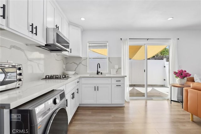 2129 N Pepper St, Burbank, CA 91505 - kitchen featuring a sink, stainless steel appliances, washer / clothes dryer, light wood-style flooring, and recessed lighting