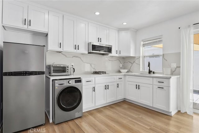 2129 N Pepper St, Burbank, CA 91505 - kitchen with washer / clothes dryer, stainless steel appliances, white cabinets, light countertops, and light wood finished floors