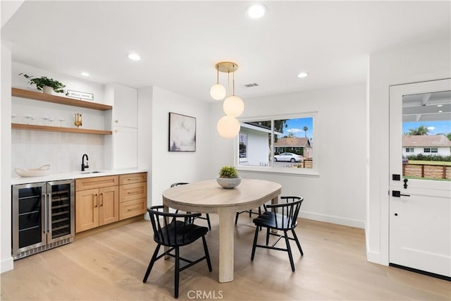 2796 Cibola Ave, Costa Mesa, CA 92626 - dining room with wine cooler, wet bar, light wood-style flooring, plenty of natural light, and recessed lighting