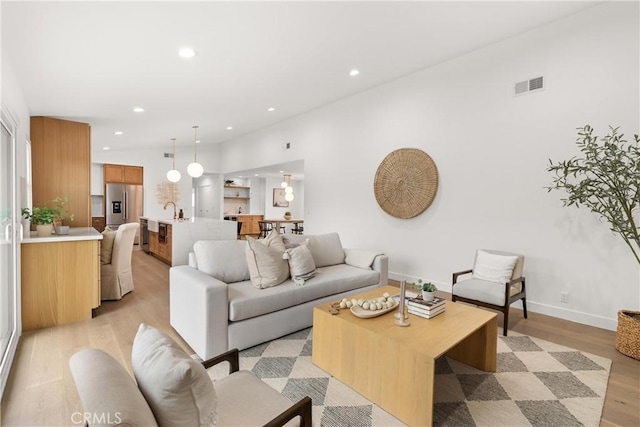 2796 Cibola Ave, Costa Mesa, CA 92626 - living area featuring light wood-style flooring, recessed lighting, and baseboards