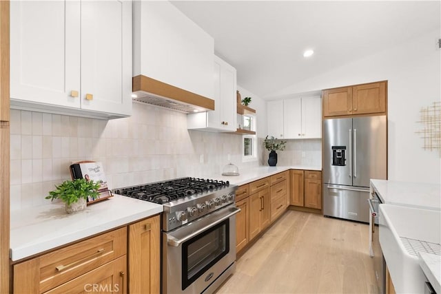 2796 Cibola Ave, Costa Mesa, CA 92626 - kitchen featuring appliances with stainless steel finishes, light wood-style floors, light countertops, lofted ceiling, and recessed lighting