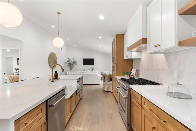 2796 Cibola Ave, Costa Mesa, CA 92626 - kitchen with stainless steel appliances, a sink, open floor plan, light wood-style flooring, and backsplash