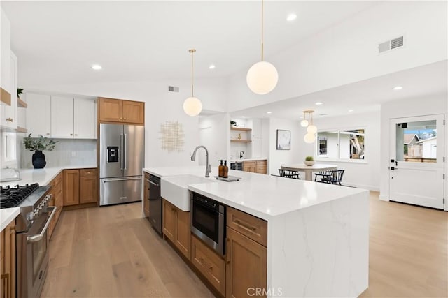 2796 Cibola Ave, Costa Mesa, CA 92626 - kitchen with high quality appliances, light wood-type flooring, backsplash, a sink, and recessed lighting