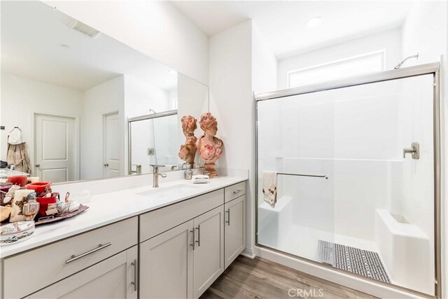 29485 Whitewood St, Menifee, CA 92584 - full bathroom featuring vanity, a shower stall, and wood finished floors