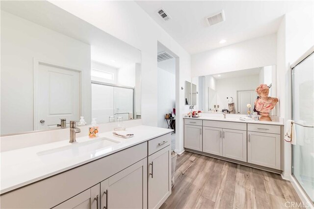29485 Whitewood St, Menifee, CA 92584 - full bath with a shower stall, two vanities, wood finished floors, and recessed lighting