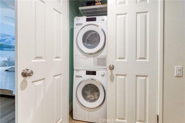 425 Old Ranch Rd, Seal Beach, CA 90740 - laundry area with stacked washer / drying machine and wood finished floors