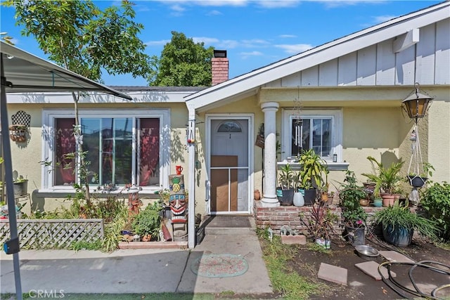 2427 Chanslor St, Pomona, CA 91766 - property entrance with a chimney, stucco siding, and board and batten siding