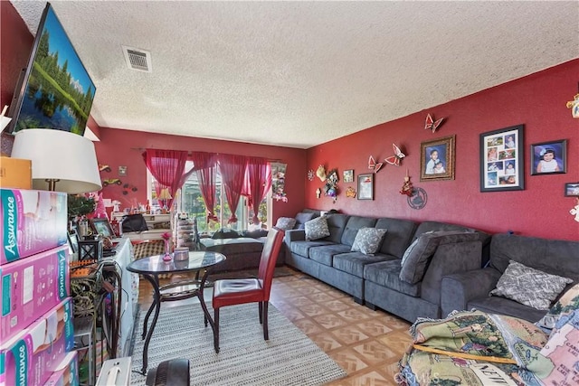 2427 Chanslor St, Pomona, CA 91766 - living room featuring a textured ceiling