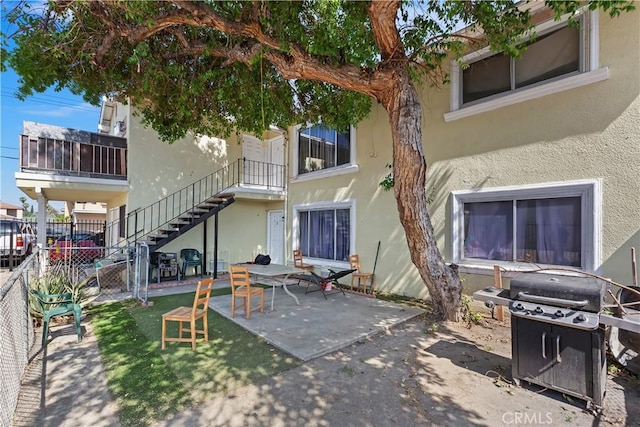 2427 Chanslor St, Pomona, CA 91766 - back of house with stucco siding, a patio, and stairway