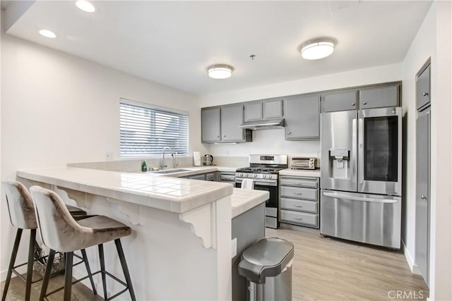 330 California St Unit F, Arcadia, CA 91006 - kitchen with stainless steel appliances, gray cabinetry, a peninsula, a breakfast bar area, and recessed lighting