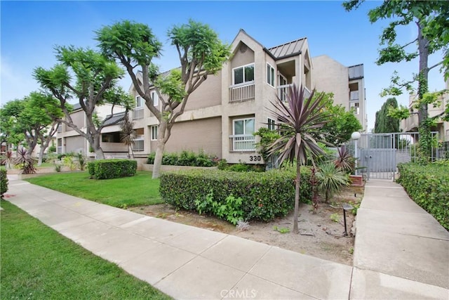 330 California St Unit F, Arcadia, CA 91006 - view of front of property featuring a standing seam roof, stucco siding, a gate, a metal roof, and a residential view