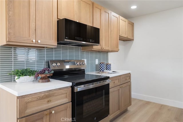 1994 11th St, La Verne, CA 91750 - kitchen featuring stainless steel range with electric stovetop, black microwave, tasteful backsplash, light wood-style flooring, and recessed lighting