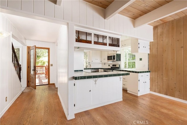 1268 Aleutian Dr, Lake Arrowhead, CA 92352 - kitchen featuring tile countertops, stainless steel appliances, light wood-style flooring, a peninsula, and healthy amount of natural light