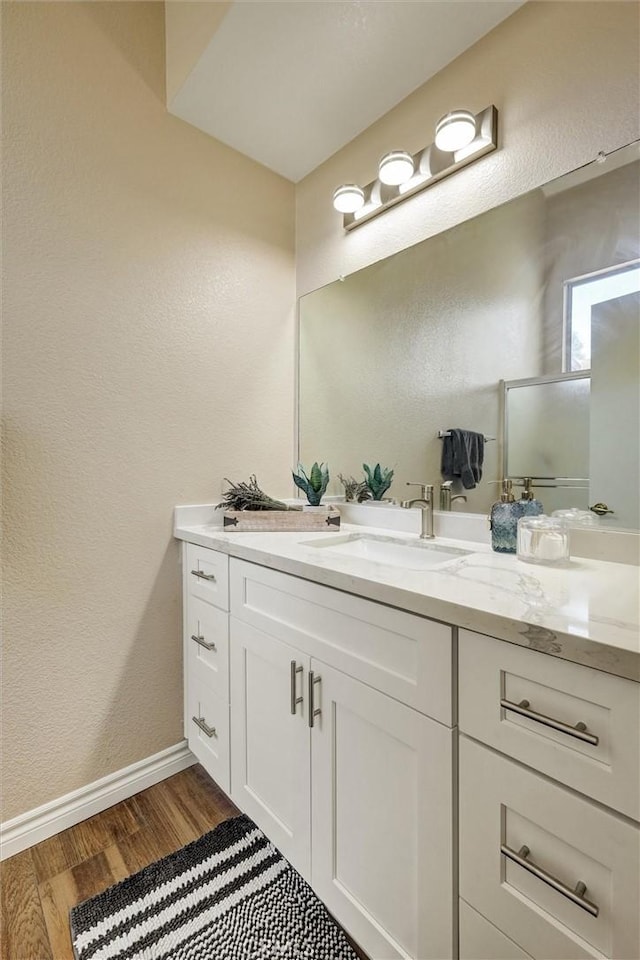 41555 Avenida De La Reina, Temecula, CA 92592 - full bath with vanity, wood finished floors, a textured wall, and a shower with shower door