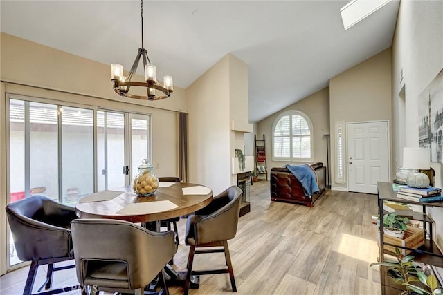 41555 Avenida De La Reina, Temecula, CA 92592 - dining area featuring a chandelier, light wood-style floors, and high vaulted ceiling