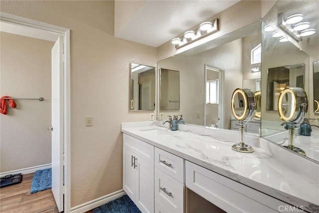 41555 Avenida De La Reina, Temecula, CA 92592 - full bathroom with double vanity, wood finished floors, and a textured wall