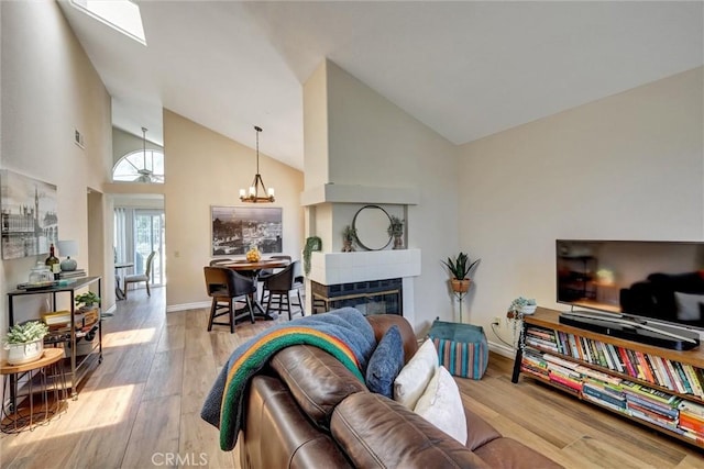 41555 Avenida De La Reina, Temecula, CA 92592 - living room featuring wood finished floors, high vaulted ceiling, and a chandelier