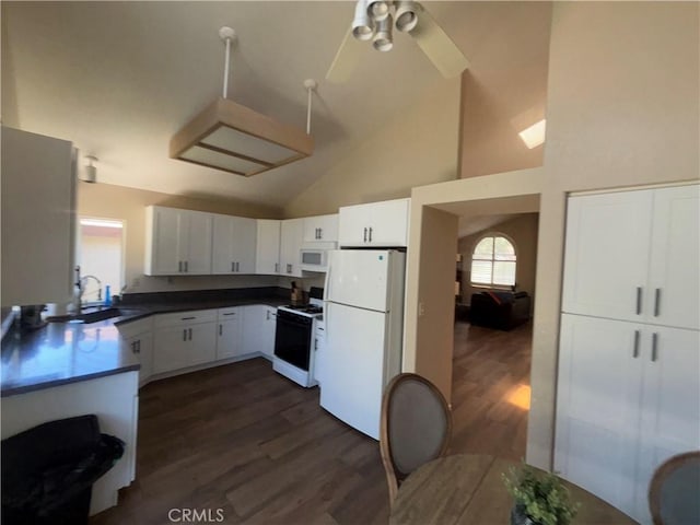 41555 Avenida De La Reina, Temecula, CA 92592 - kitchen with white appliances, high vaulted ceiling, dark wood-style flooring, white cabinetry, and dark countertops