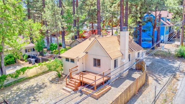 1131 Apple Ave, Wrightwood, CA 92397 - back of house featuring a shingled roof, a wooden deck, and a chimney