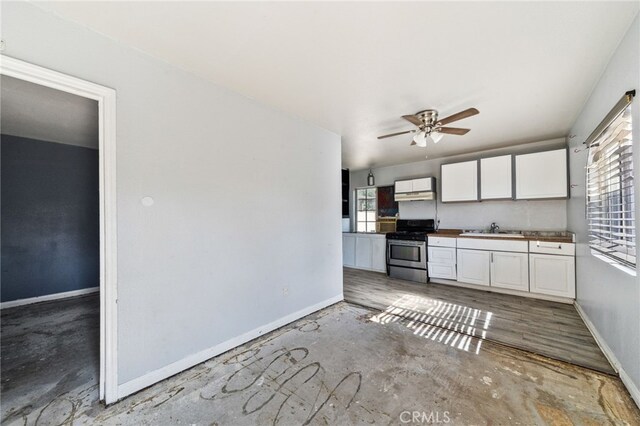 5294 Yosemite Dr, San Bernardino, CA 92407 - kitchen with stainless steel range with gas stovetop, white cabinetry, a ceiling fan, and unfinished concrete floors