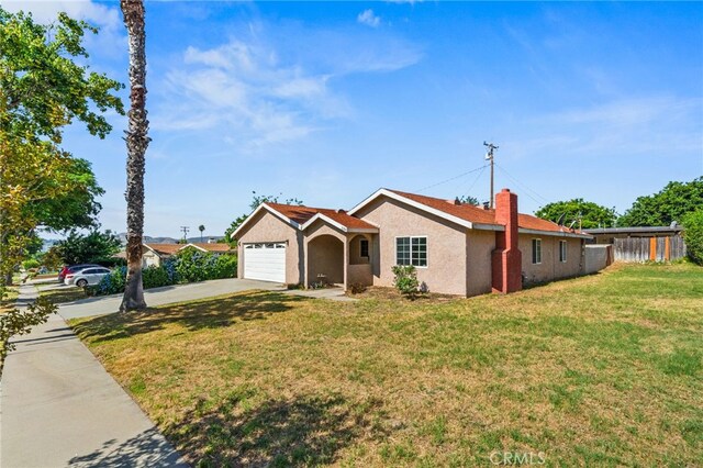 5294 Yosemite Dr, San Bernardino, CA 92407 - ranch-style house with concrete driveway, a front lawn, a garage, and stucco siding
