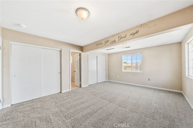 5294 Yosemite Dr, San Bernardino, CA 92407 - unfurnished bedroom with carpet and two closets