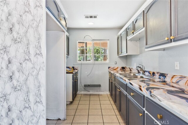5294 Yosemite Dr, San Bernardino, CA 92407 - kitchen featuring light tile patterned flooring and light countertops