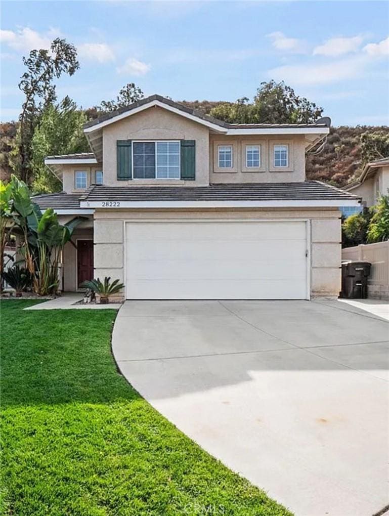 28222 Cascade Rd, Castaic, CA 91384 - view of front of house featuring an attached garage, stucco siding, and driveway