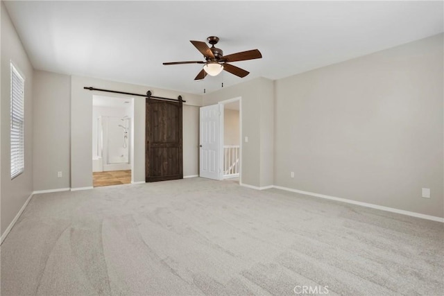 31713 Pompei Ln, Winchester, CA 92596 - unfurnished bedroom with a barn door, carpet, multiple windows, and ceiling fan
