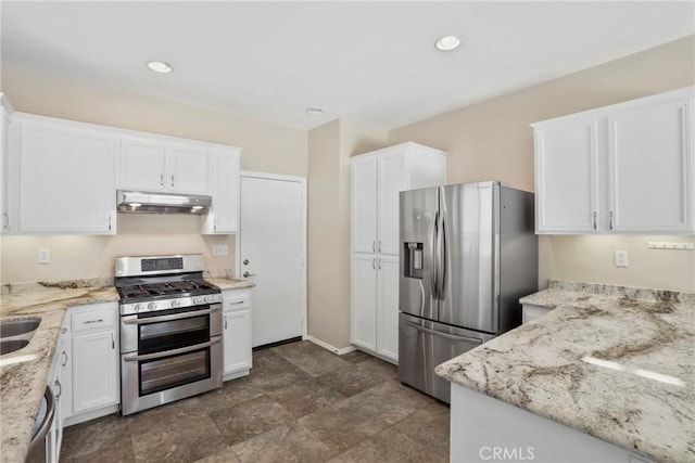 31713 Pompei Ln, Winchester, CA 92596 - kitchen with stainless steel appliances, under cabinet range hood, white cabinetry, light stone counters, and recessed lighting