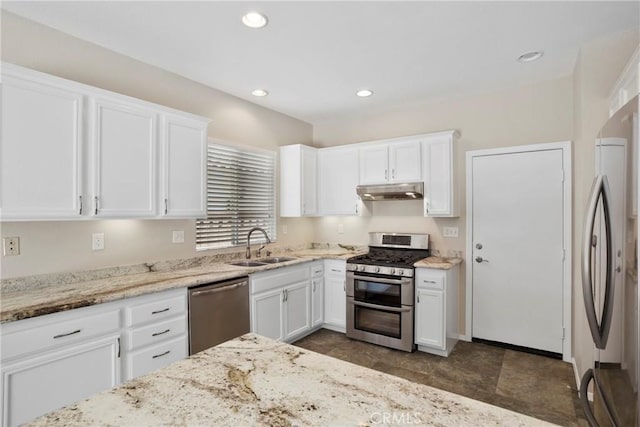 31713 Pompei Ln, Winchester, CA 92596 - kitchen featuring appliances with stainless steel finishes, under cabinet range hood, white cabinets, light stone countertops, and recessed lighting