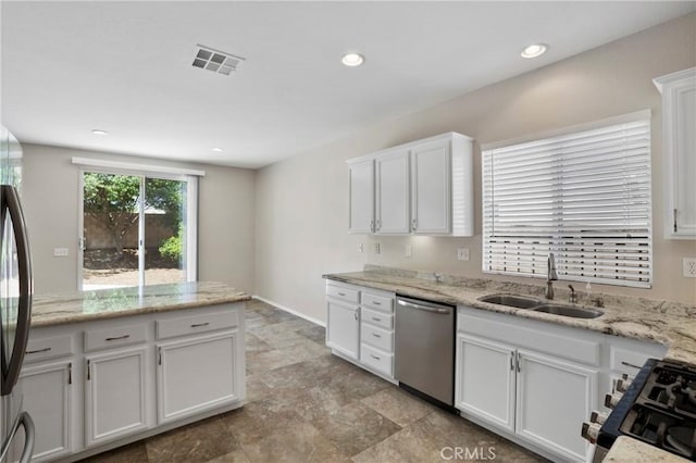 31713 Pompei Ln, Winchester, CA 92596 - kitchen featuring dishwasher, range with gas cooktop, white cabinets, light stone countertops, and stone finish floors