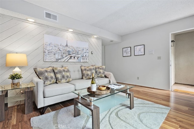 12562 Montecito Rd Unit 3, Seal Beach, CA 90740 - living room with wood finished floors, a textured ceiling, and wooden walls