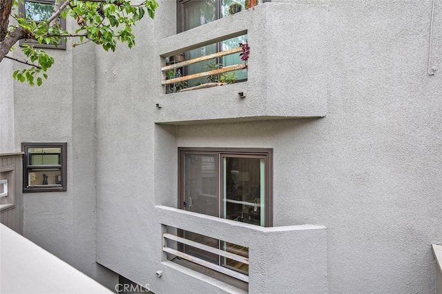 12562 Montecito Rd Unit 3, Seal Beach, CA 90740 - property entrance featuring a balcony and stucco siding