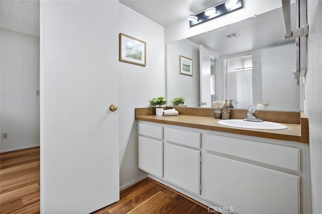 12562 Montecito Rd Unit 3, Seal Beach, CA 90740 - bathroom with vanity, wood finished floors, and baseboards