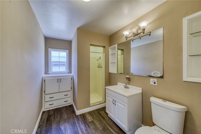 503 California Ave, Needles, CA 92363 - bathroom featuring wood finished floors, vanity, toilet, a shower stall, and baseboards