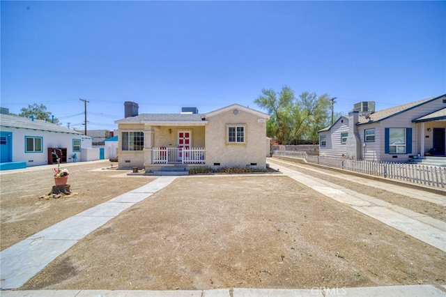 503 California Ave, Needles, CA 92363 - view of front of house with stucco siding, crawl space, and a porch