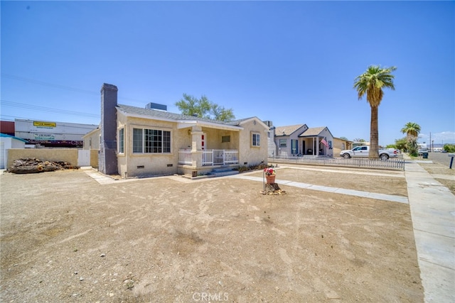 503 California Ave, Needles, CA 92363 - view of front facade with a chimney, crawl space, and stucco siding