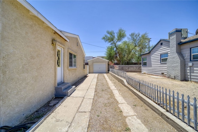 503 California Ave, Needles, CA 92363 - view of patio featuring concrete driveway, a detached garage, and an outdoor structure