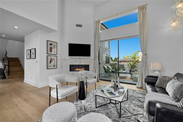 2004 Grant Ave Unit B, Redondo Beach, CA 90278 - living room with stairs, light wood finished floors, a high end fireplace, a towering ceiling, and recessed lighting